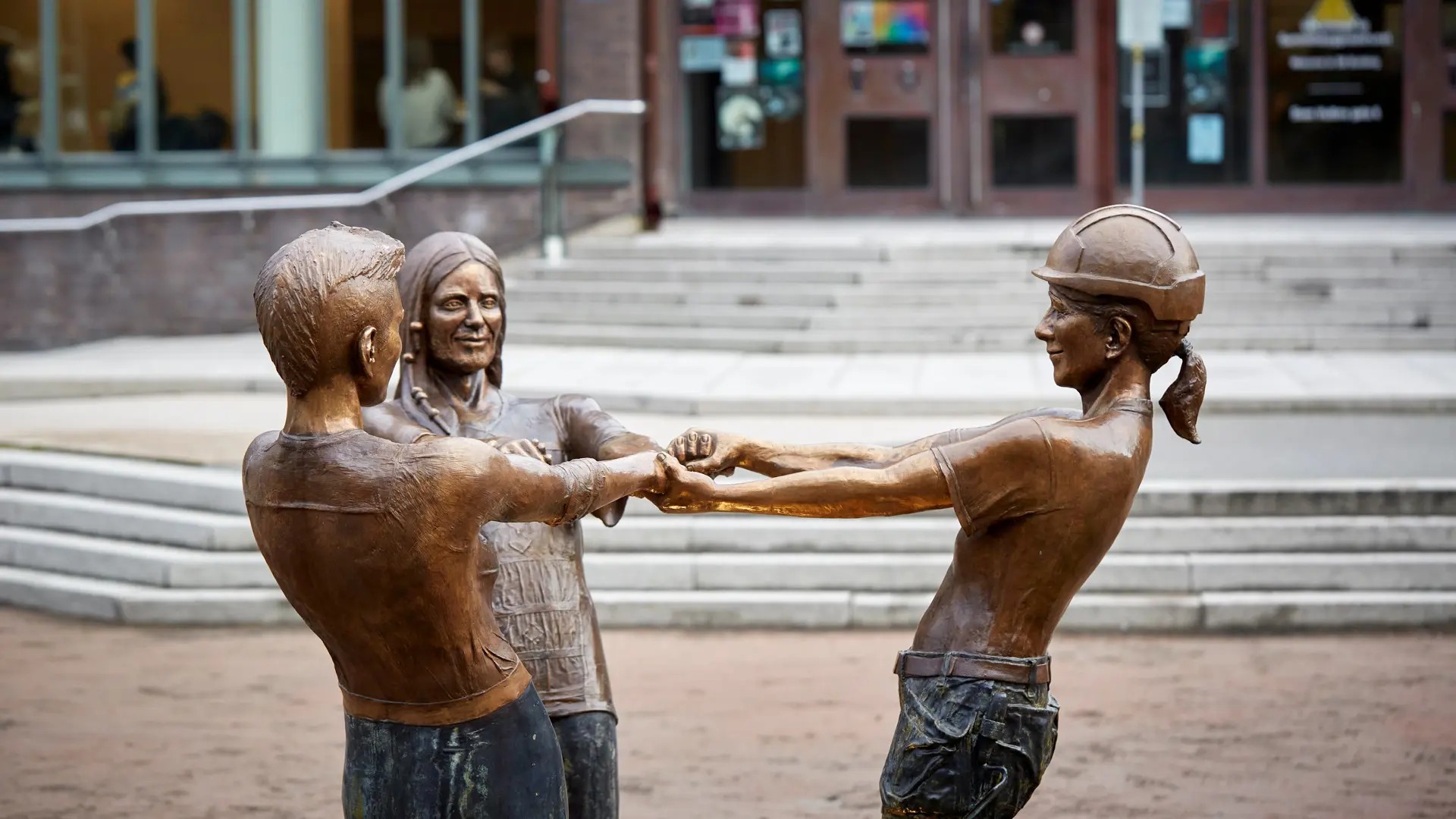 Sculpture of students holding hands