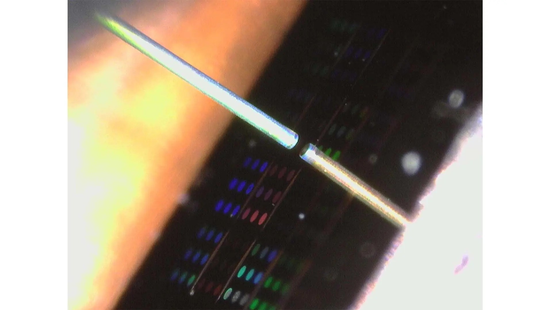 An optical fiber facing a mirror chip - a miniature cavity optomechanical device.