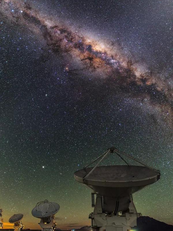Some of the ALMA telescope antennas, beneath the central regions of the Milky Way. 