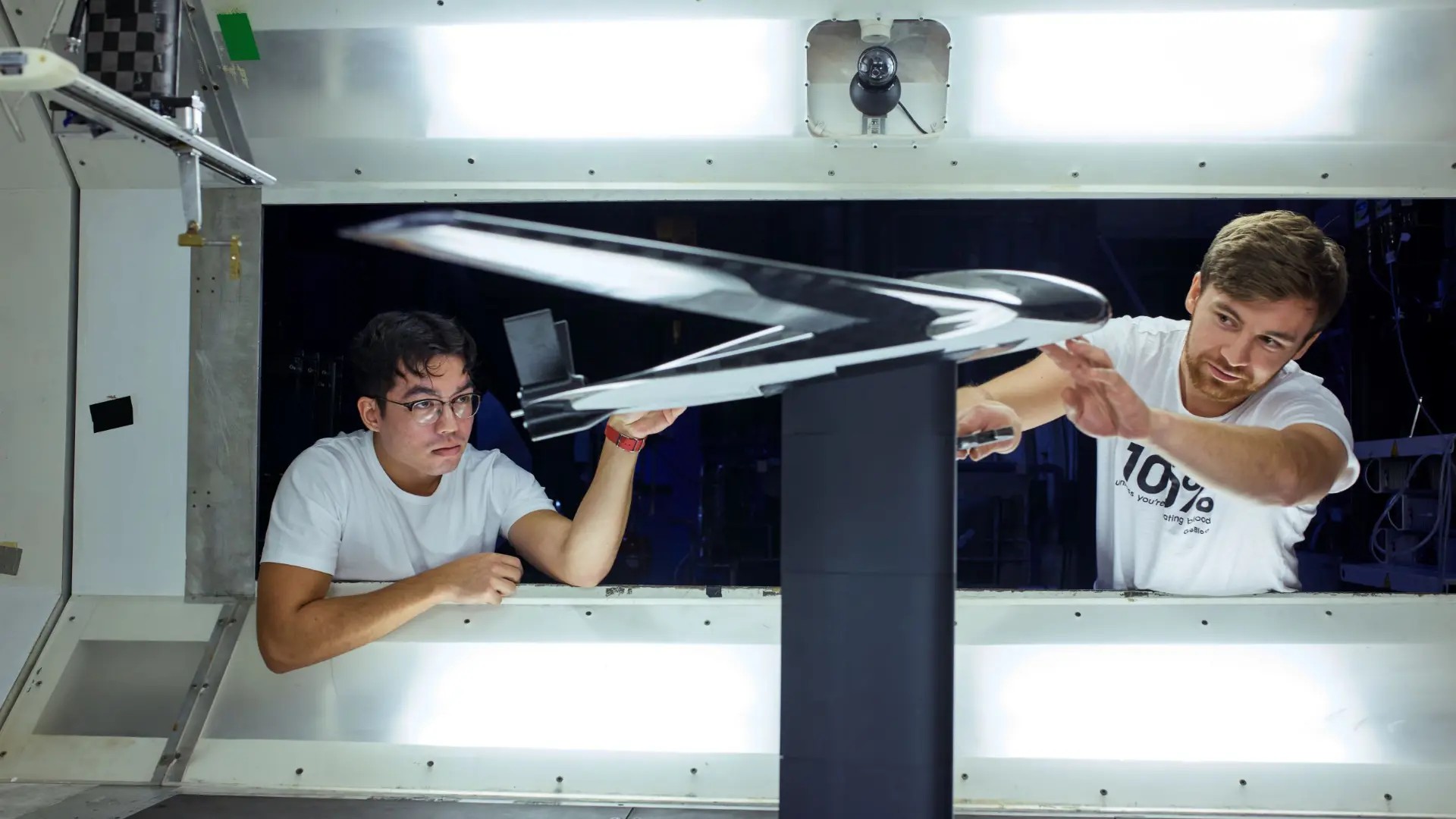 Researchers with a drone in wind tunnel